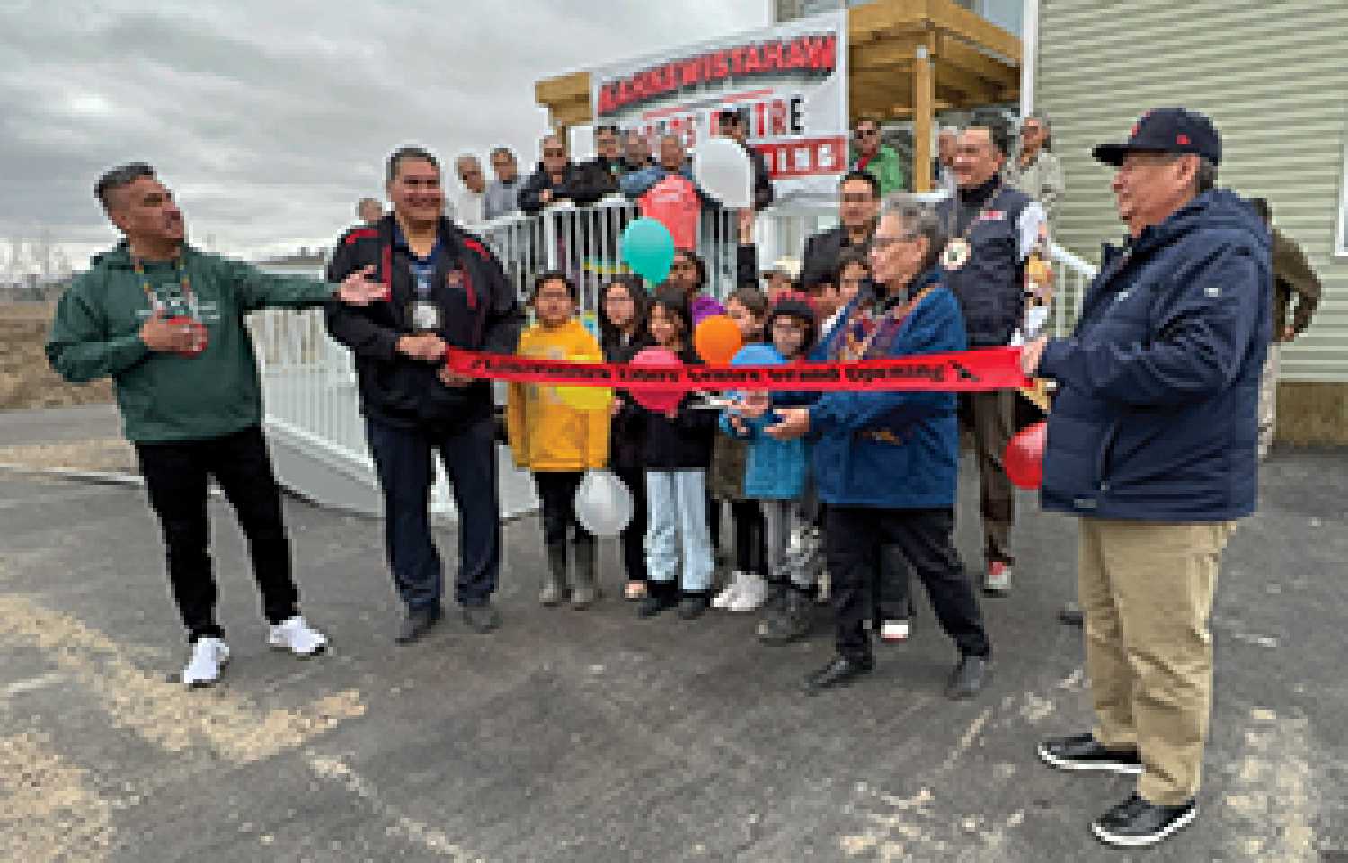 Elder Amanda Louison cuts the ribbon to officially open the new Kahkewistahaw First Nation Elder’s Centre on April 17 as community members look on, including (from left) Chief Evan Taypotat, Councillor Michael Bob, FSIN vice-chief Fabian Head, and Councillors Cory Alexson and William Kaysaywaysemat.